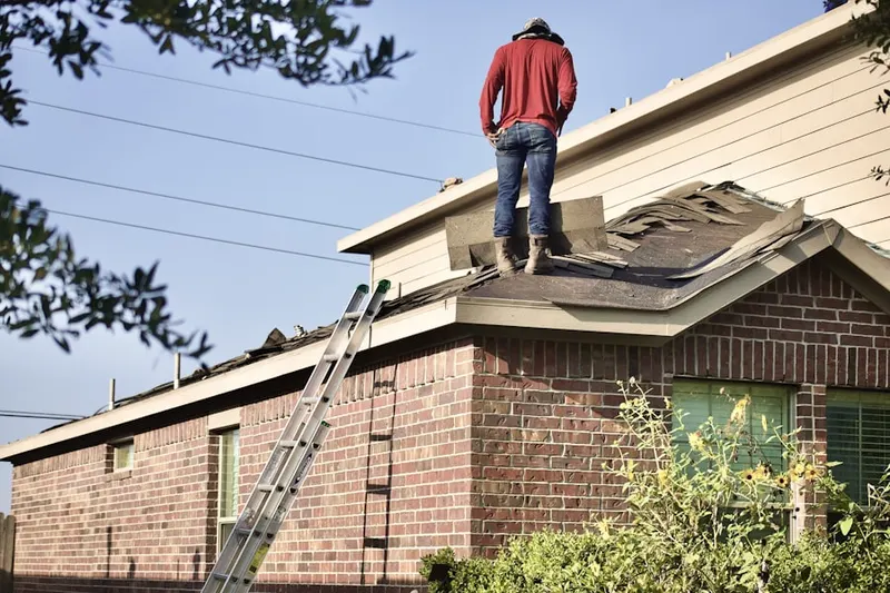 Professional roofer working on a residential roof in River Valley Estates